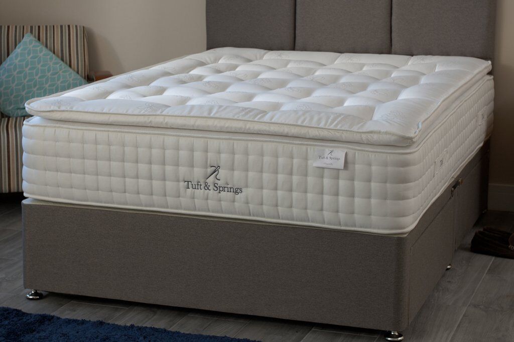 A Tuft & Springs Chantilly 3000 Pocket Natural Pillow Top Mattress positioned on top of a divan bed